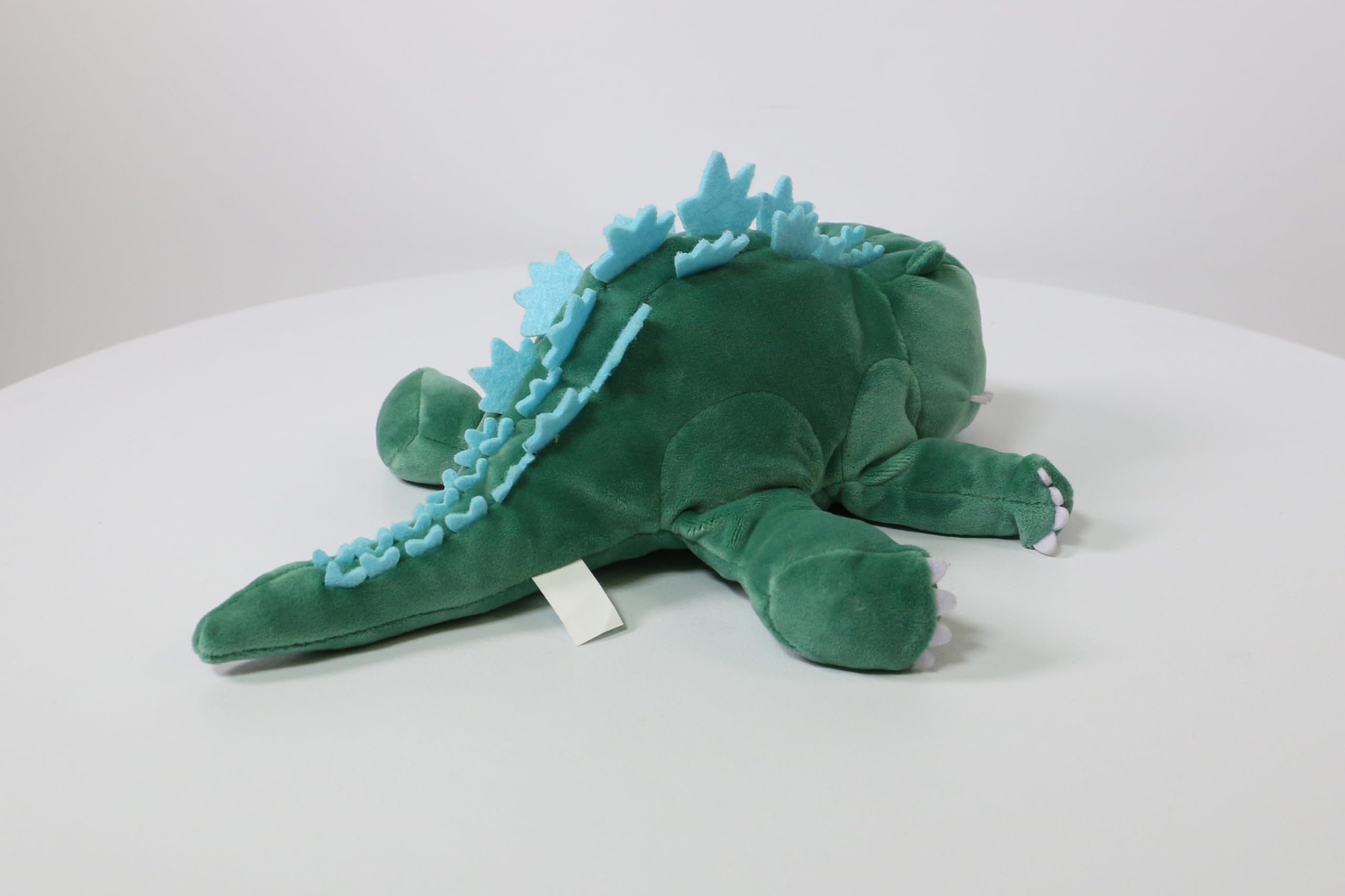 Surreal Entertainment Godzilla plush shows sleepy smile for gentle play.