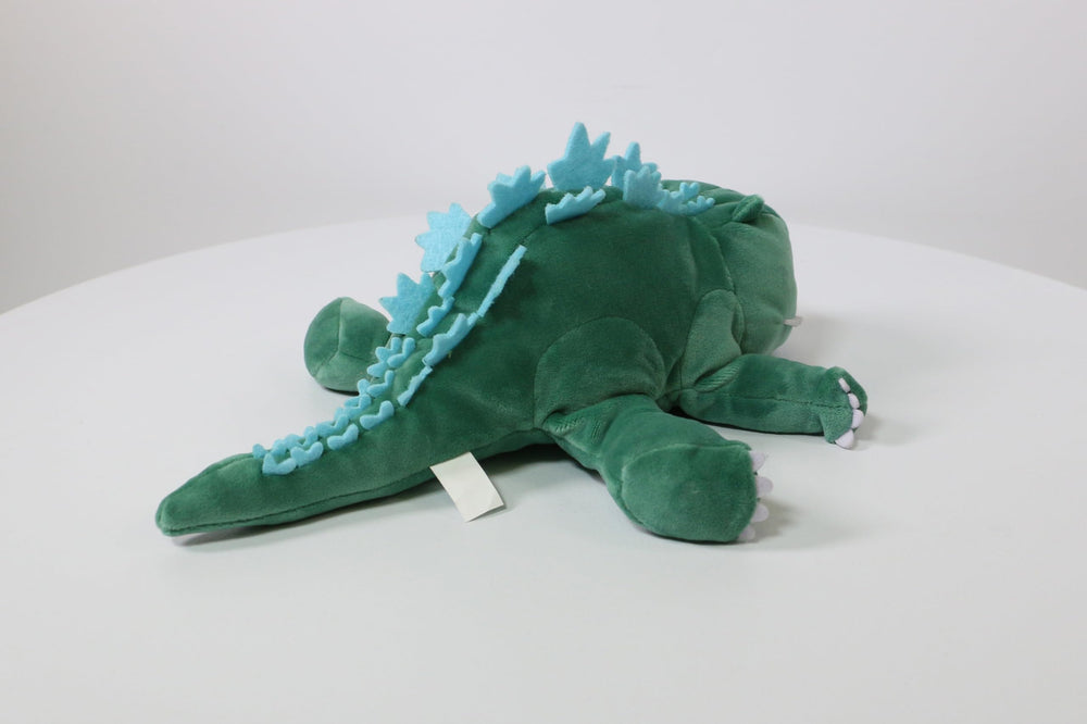 Surreal Entertainment Godzilla plush shows sleepy smile for gentle play.