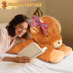 SuzziPals Highland Cow plush on a bed adds playful charm to a nursery