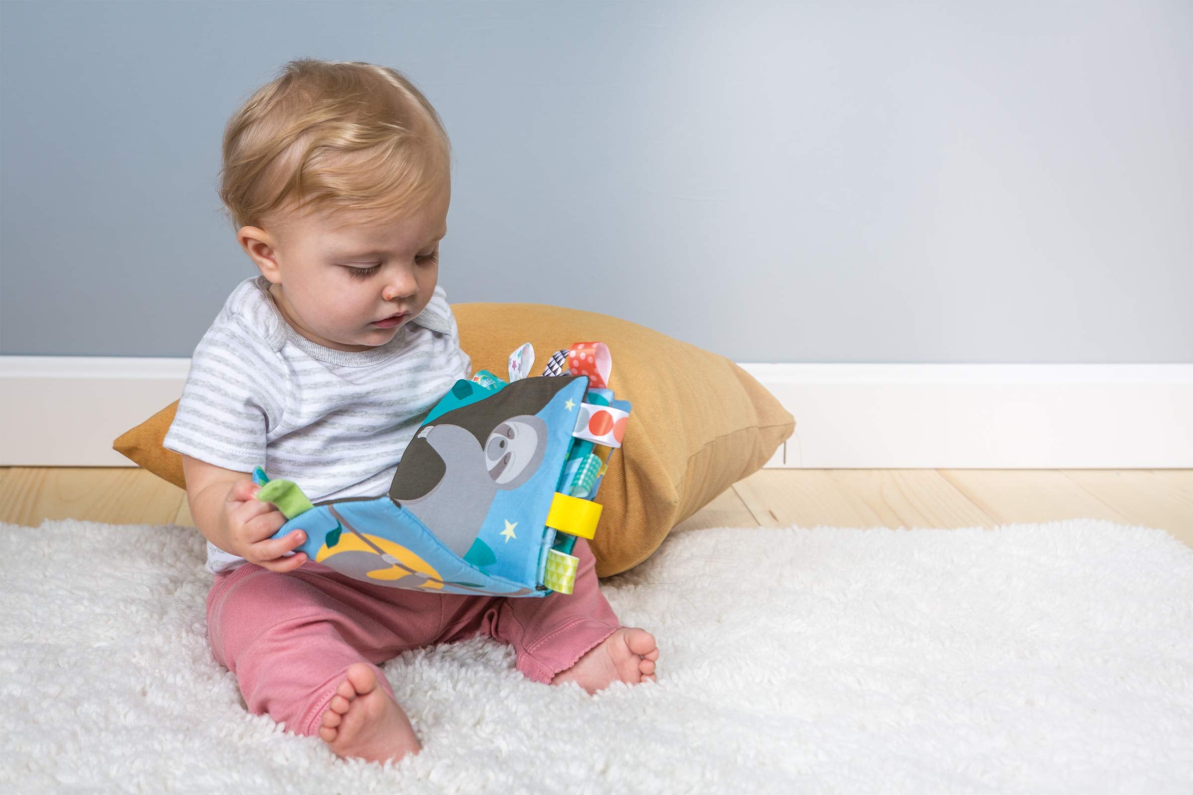 Taggies book with attached tags supports exploration and soothing tactile moments.
