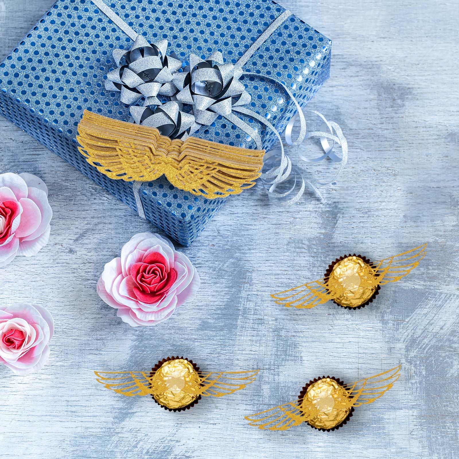 Teaaha gold glitter wings topper shines under light for party sparkle.