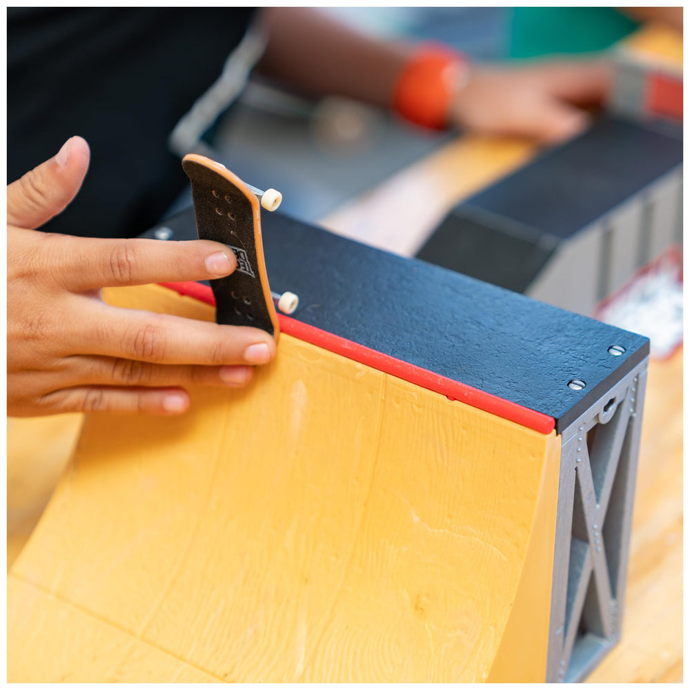 Fingerboard performing a jump on the 20-inch ramp