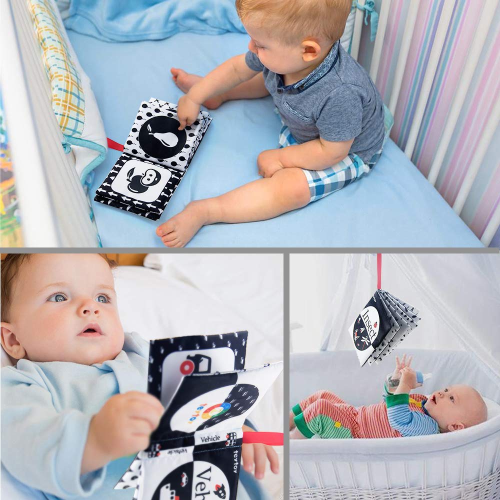 Teytoy My First Soft Book baby holding a book demonstrates early interaction and curiosity.