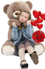 Tezituor 40-inch giant teddy bear in a cozy bedroom, ready for hugs.