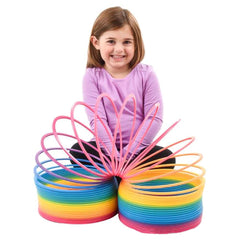 Bright rainbow coil spring bounce action sparks giggles during hallway play.