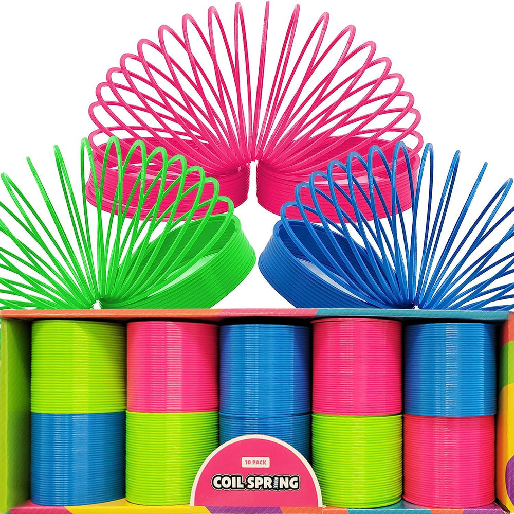 The Dreidel Company neon coil springs arranged as party favors on a kids' party table for play.