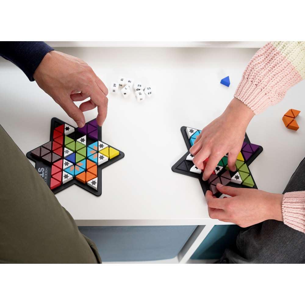 The Happy Puzzle Company Genius Star dice rolled at game start.