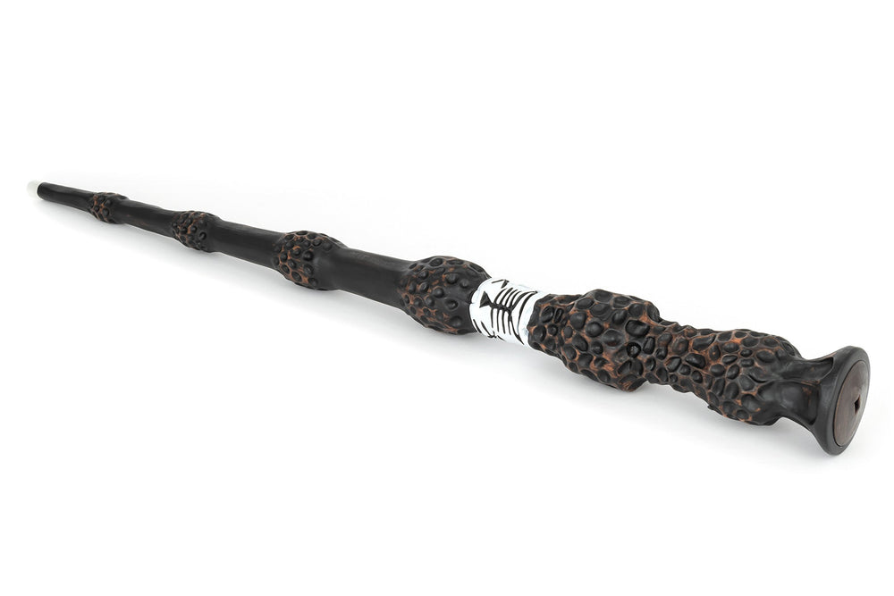 The Noble Collection Elder Wand glowing tip in a dark shelf setup.