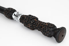 The Noble Collection Elder Wand in off state beside battery area.