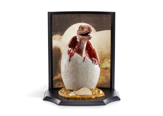 Baby Velociraptor figure with egg backdrop for collectible display.