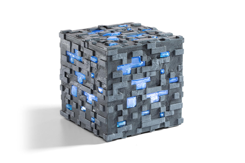 The Noble Collection Minecraft Diamond Ore light-up block displayed on a desk for ambiance.