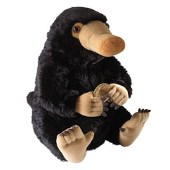 The Noble Collection Niffler Plush on a desk, perfect for a magical display.