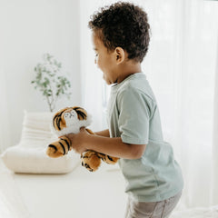 The Petting Zoo tiger stuffed animal inviting kids to storytelling and pretend safari.