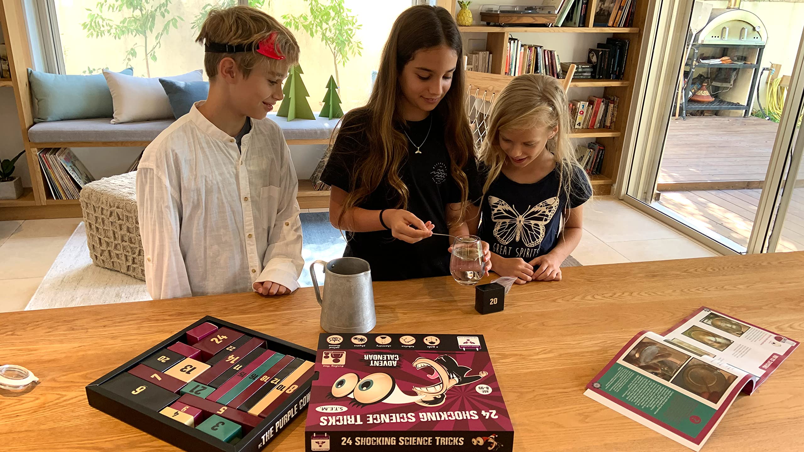 Kids playing with The Purple Cow Advent Calendar for family learning and fun.