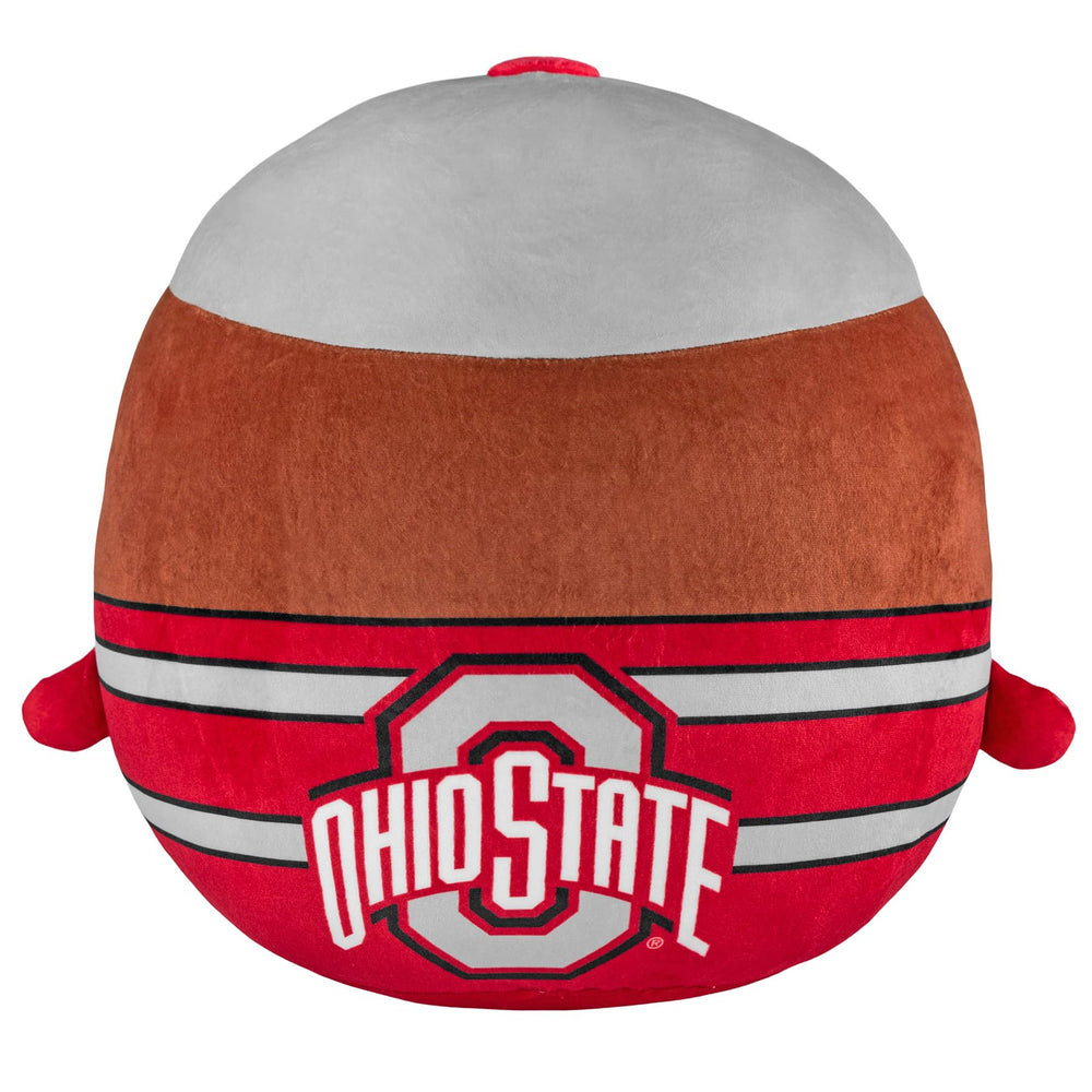 Brutus 12-inch plush on bed, cozy dorm decor.