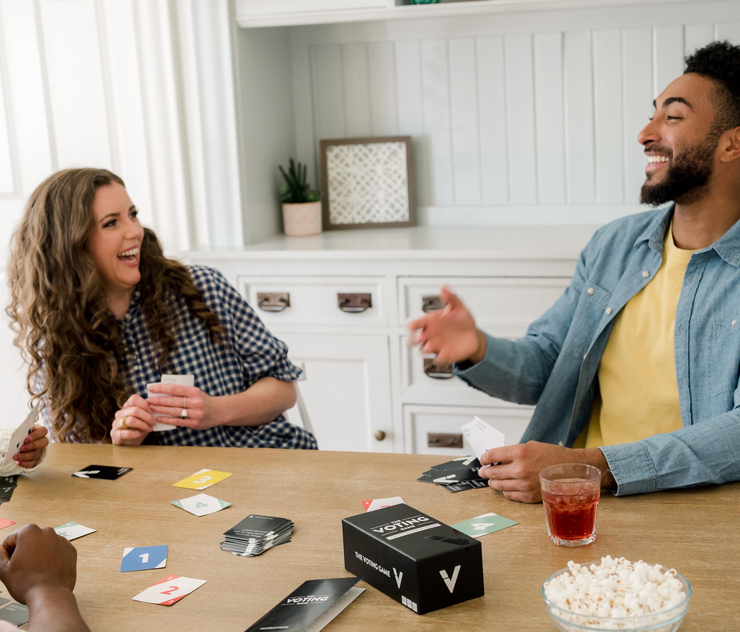 The Voting Game group playing at a table, perfect for game nights.