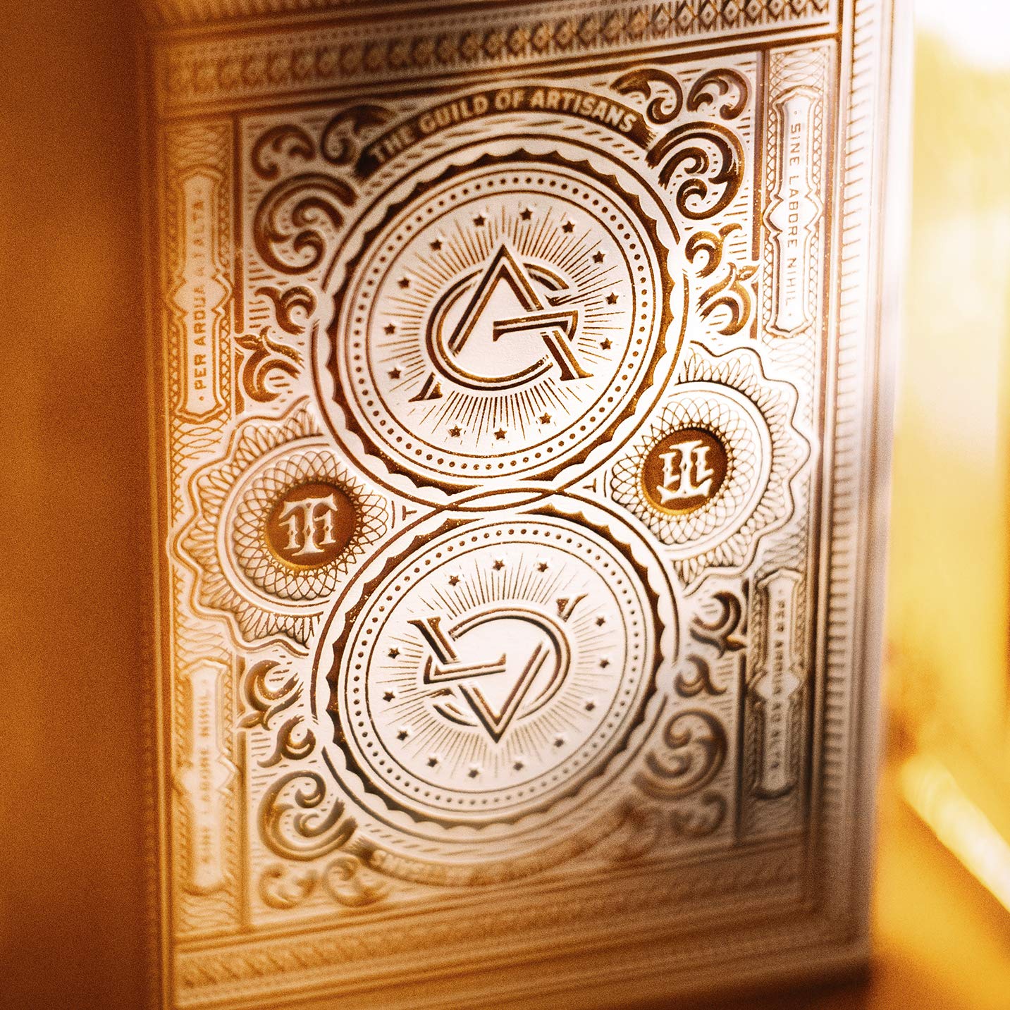 theory11 Artisan Playing Cards White Edition close up shows gold foil on black stock
