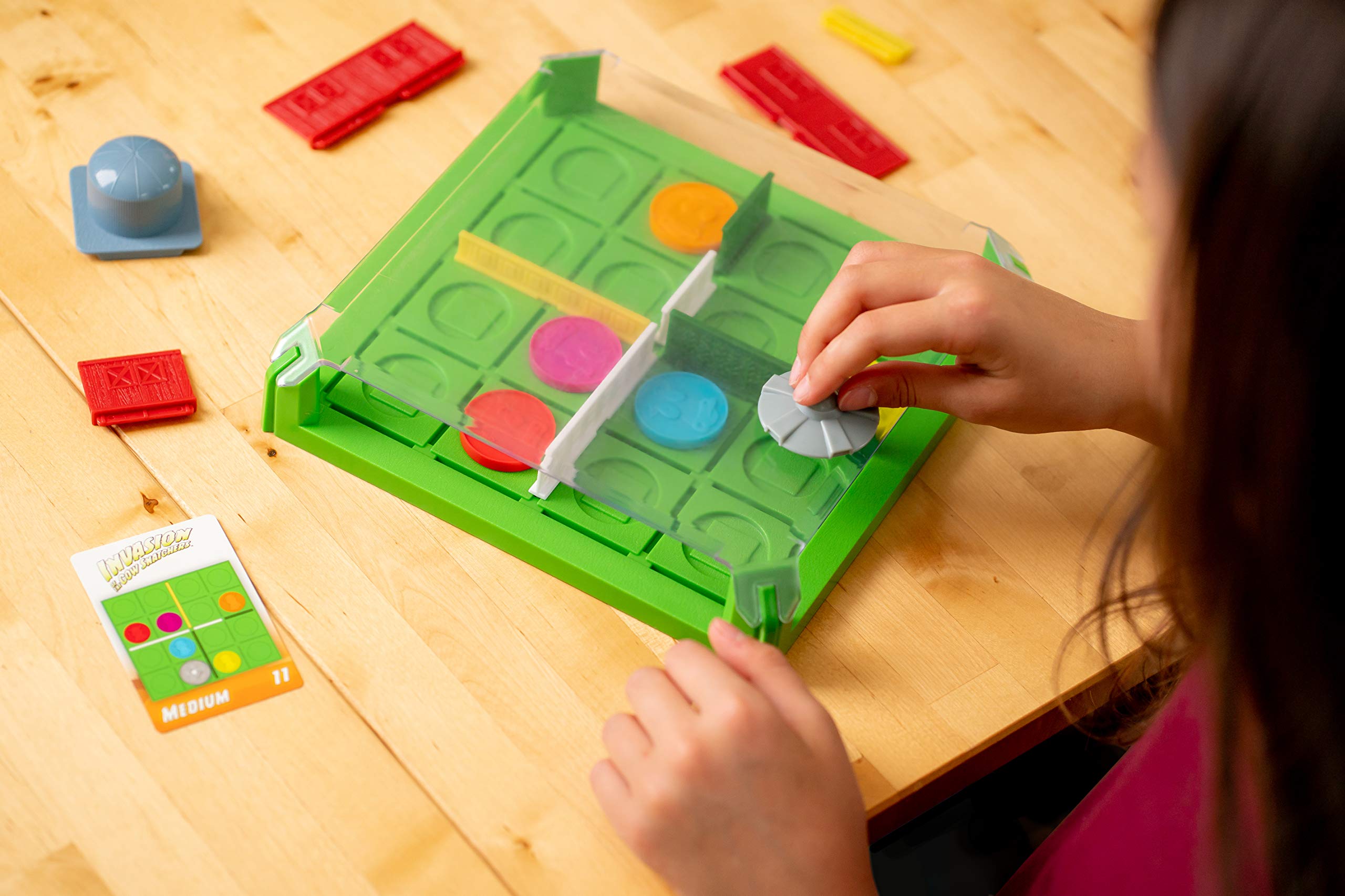 ThinkFun Invasion of the Cow Snatchers magnetic tokens used for puzzle strategy.