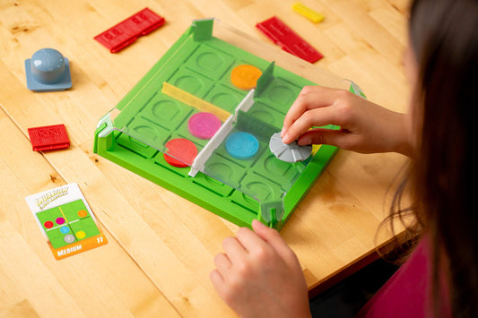 ThinkFun Invasion of the Cow Snatchers magnetic tokens used for puzzle strategy.