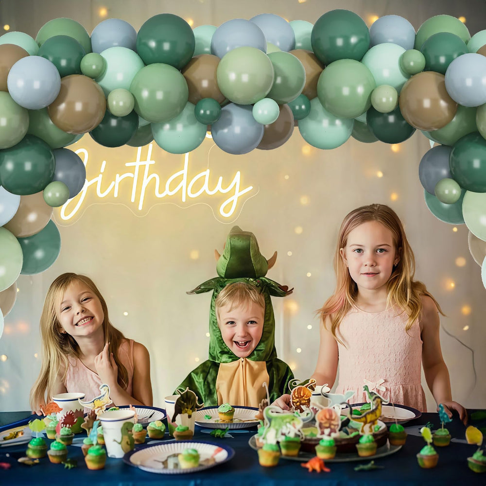 TOGVU dino baby shower balloons creating a playful backdrop.
