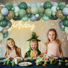 TOGVU dino baby shower balloons creating a playful backdrop.