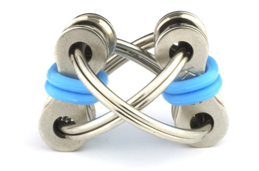 Tom's Fidgets blue chain fidget resting on desk for silent, distraction-free concentration.