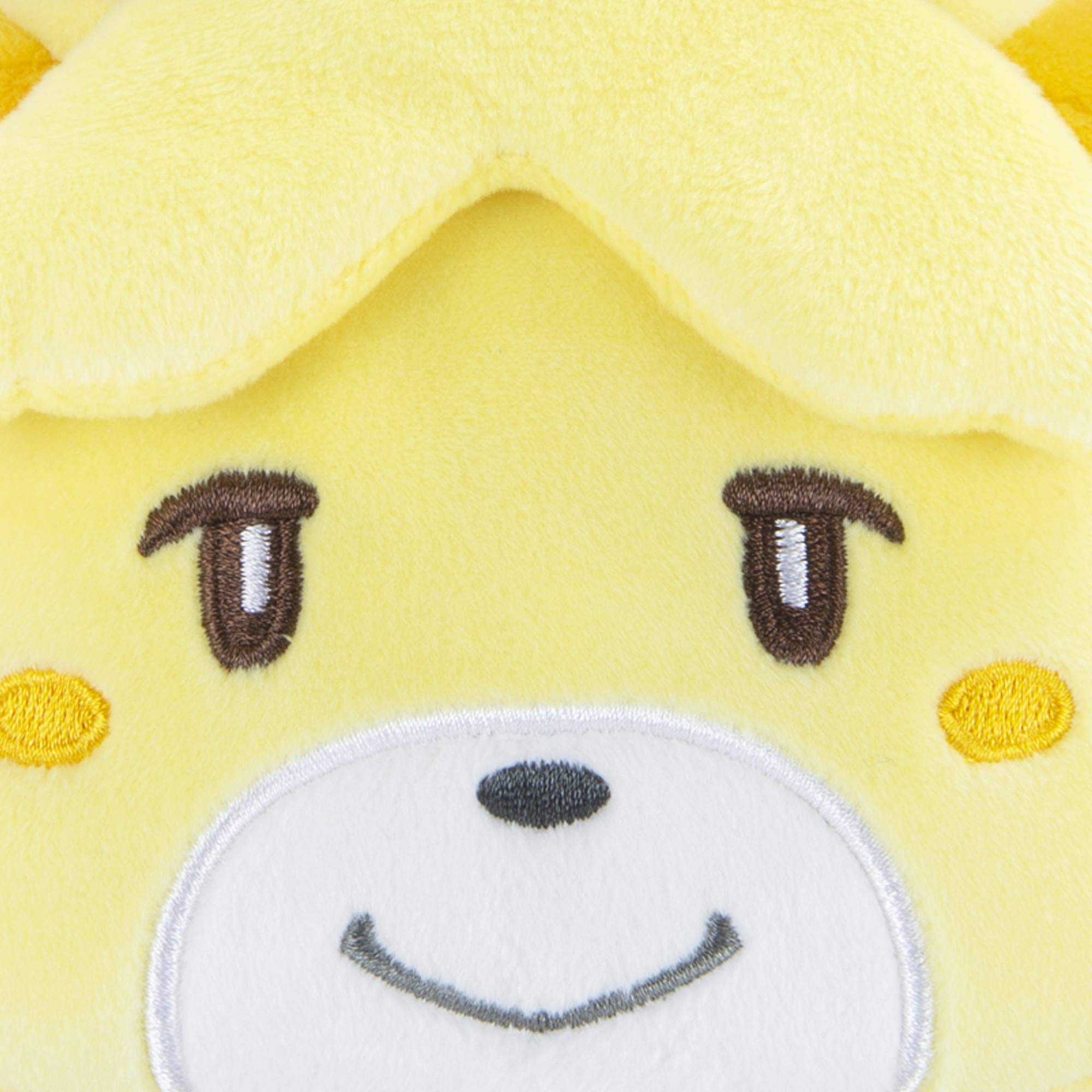 Tomy Isabelle face closeup, showcasing soft plush texture for cuddling