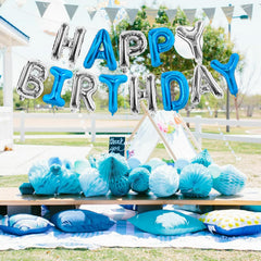 Living room setup featuring TONIFUL navy-silver birthday banner.