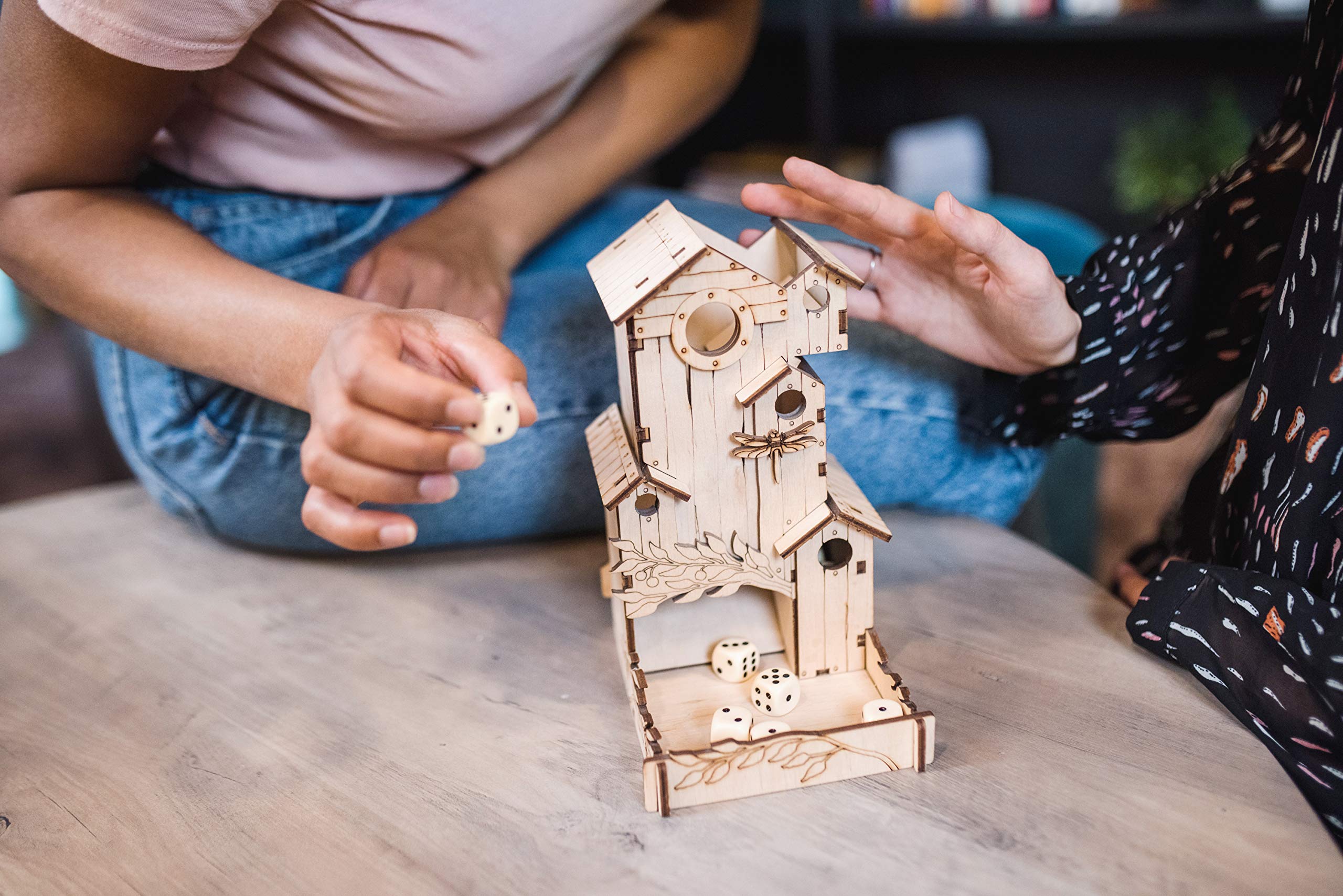 TowerRex Dice Tower table-top accessory enhances gaming ambiance.