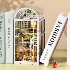 TOYQI Book Nook Kit garden accents and cats add charm to shelves.