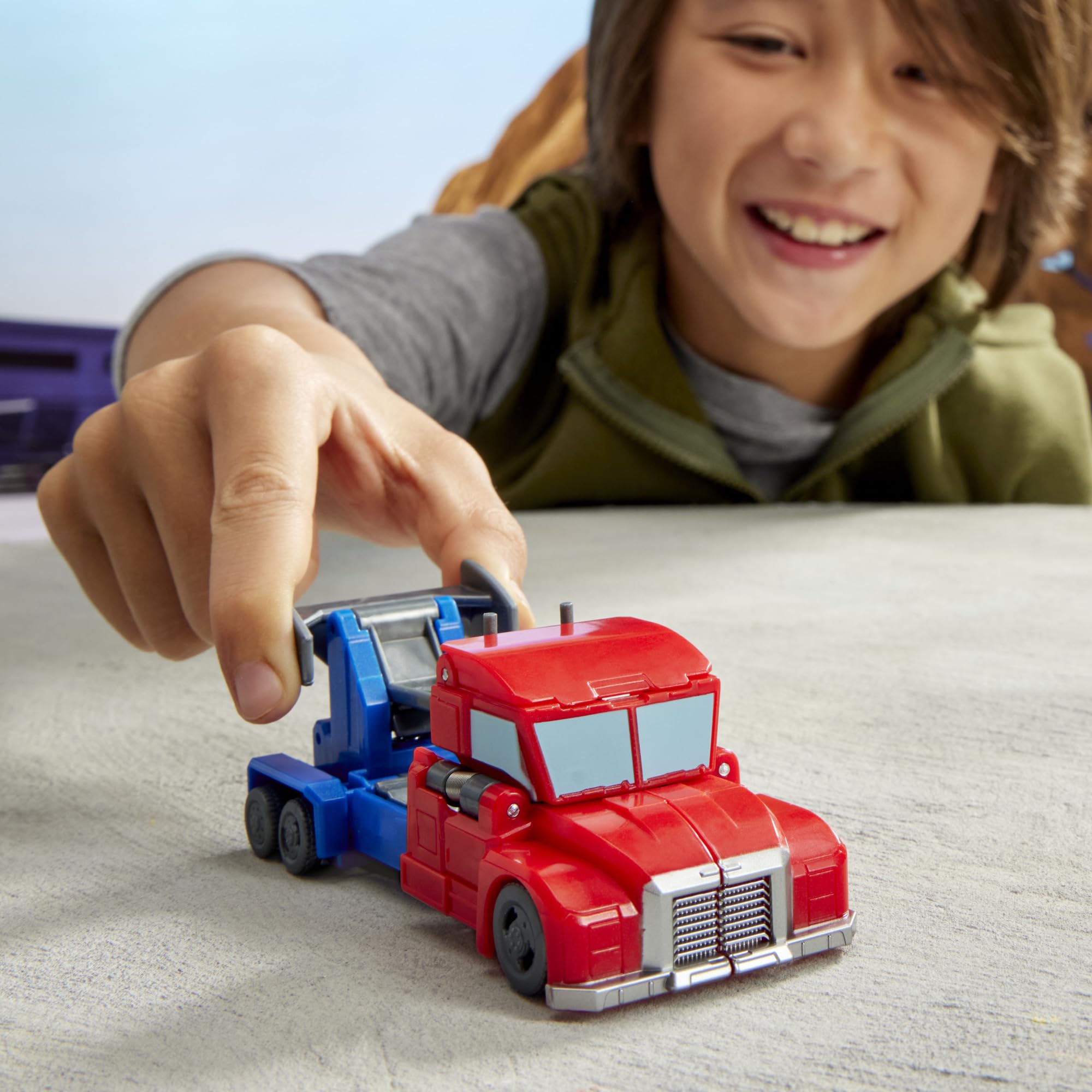 Transformers EarthSpark Optimus Prime toy in a play-ready package.