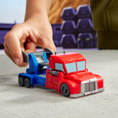 Transformers EarthSpark Optimus Prime smash action on a flat surface.