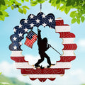 TT & MM Sasquatch wind spinner spins with the American flag for outdoor decor.