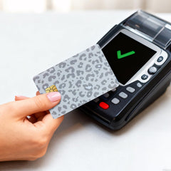 TUCEWP EMV cutouts on leopard card skin keep tap payments quick.