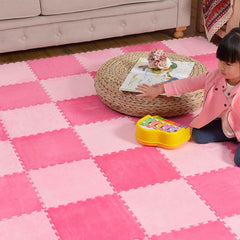 Typutomi kids playing on the soft, cushioned play area.