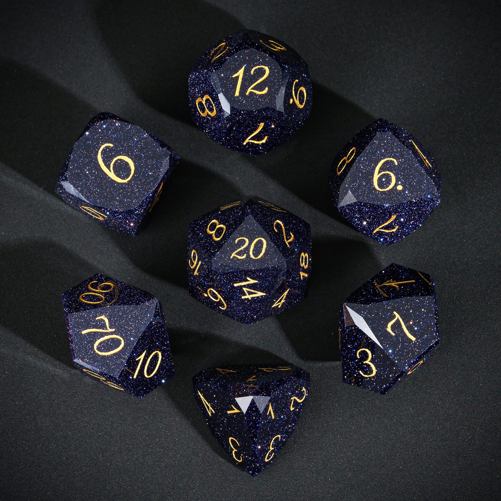UDIXI blue sandstone gemstone dice closeup showing sparkling facets.
