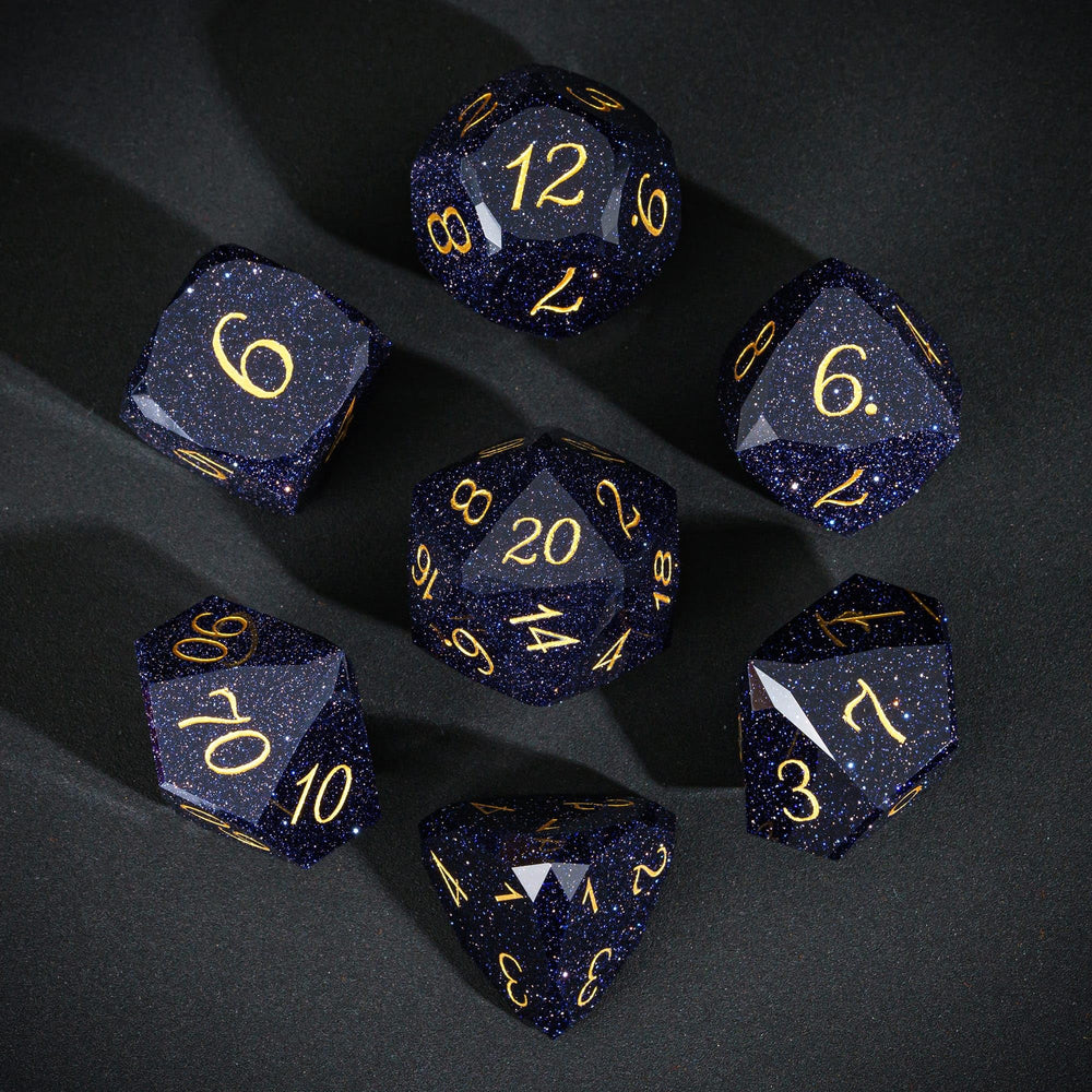 UDIXI blue sandstone gemstone dice closeup showing sparkling facets.
