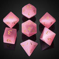 UDIXI Pink Cat's Eye gemstone dice set close-up showing natural textures for tabletop gameplay