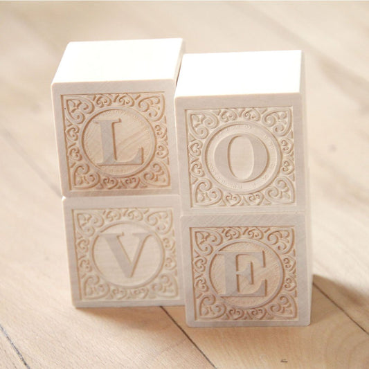 Uncle Goose embossed capital letters on cubes support versatile building and literacy practice.