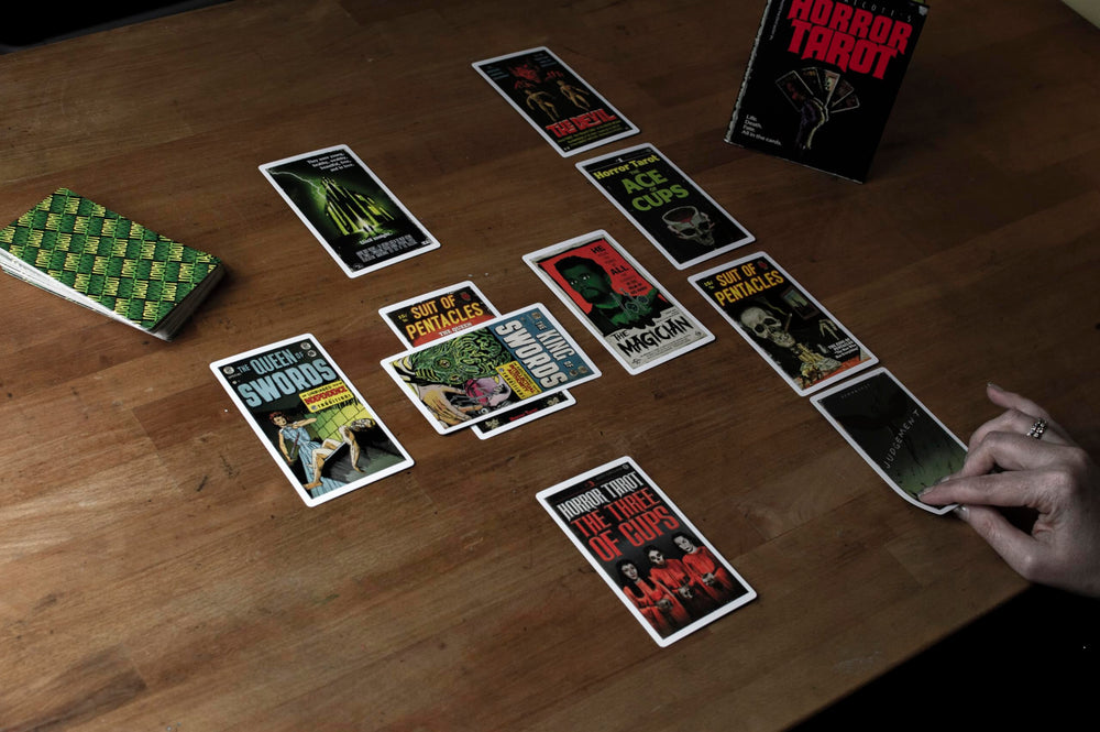 Todd Alcott horror tarot deck spread showing layout and colors.