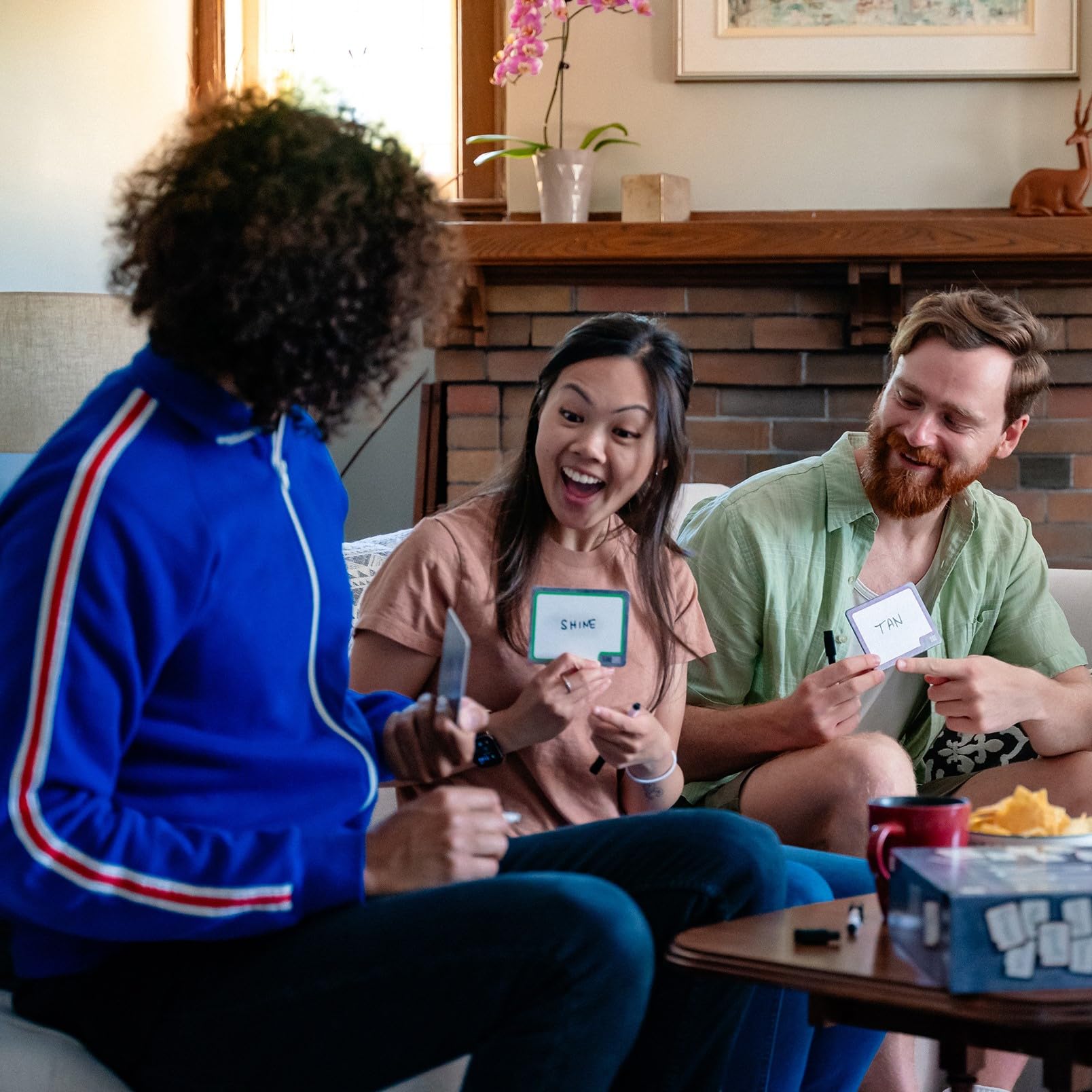 Lively group playing USAOPOLY Blank Slate during a family gathering.