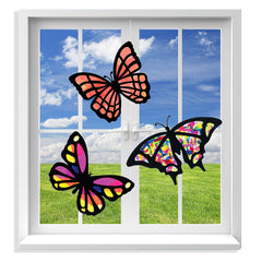 VHALE butterfly suncatcher kit in progress with colorful tissue near a sunlit window.