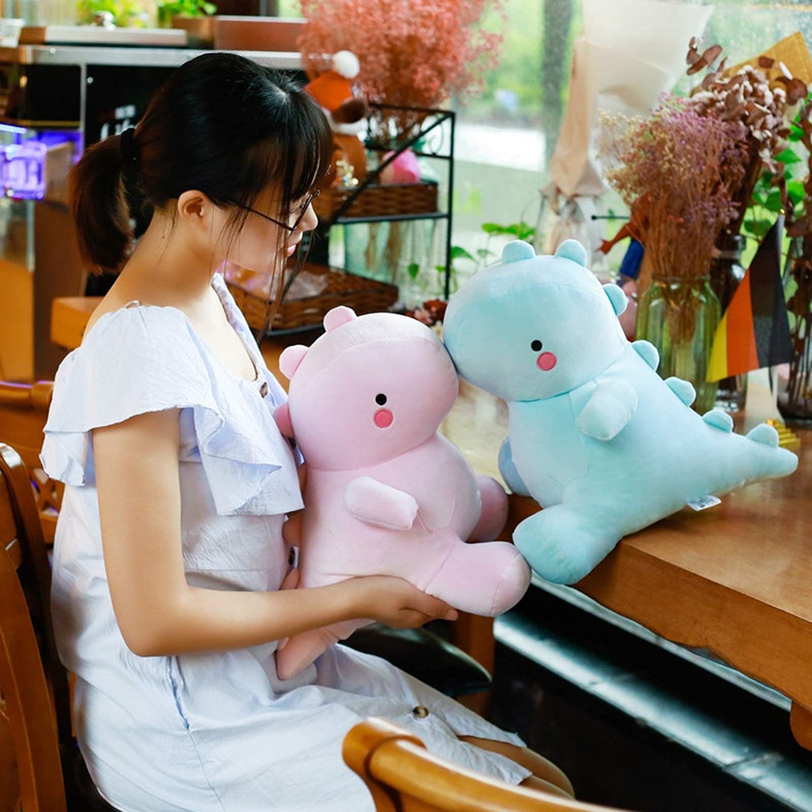VHYHCY dinosaur plush used as a cozy reading pillow for kids.