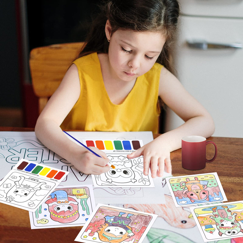 Child using a wet brush on color squares, playful learning moment.