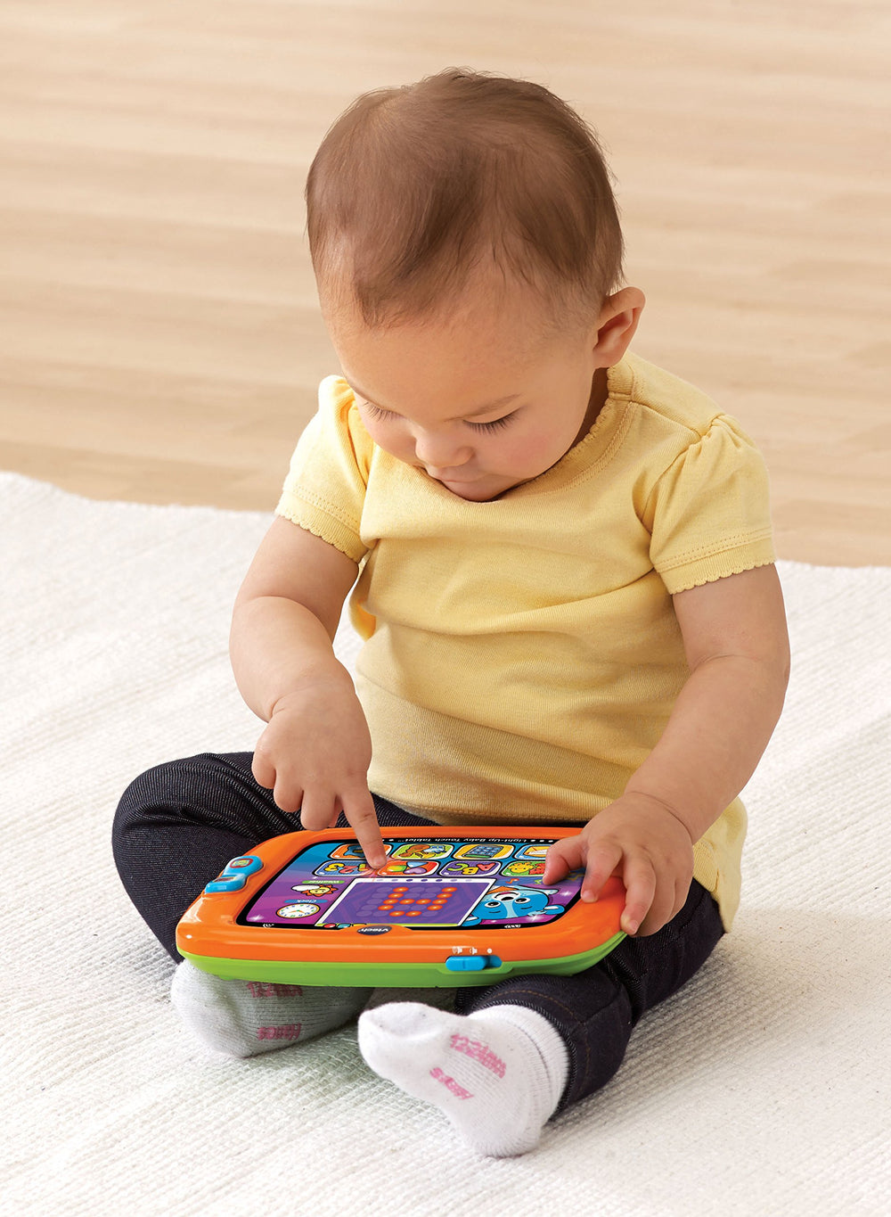 VTech Light-Up Baby Touch Tablet orange swipe screen demonstrates easy navigation for kids.