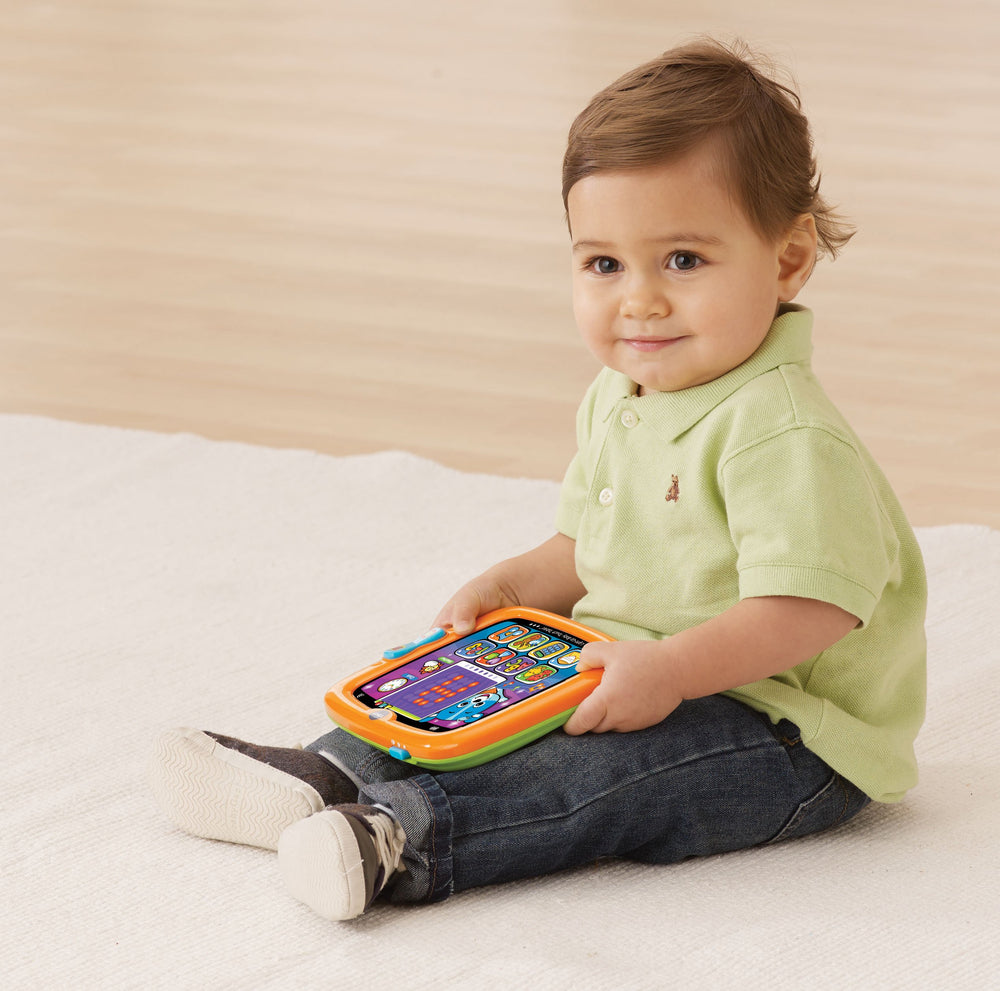 VTech orange tablet screen showing apps and bright lights for learning play.