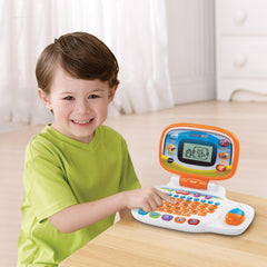 Child uses the orange VTech laptop for hands-on learning on the go.