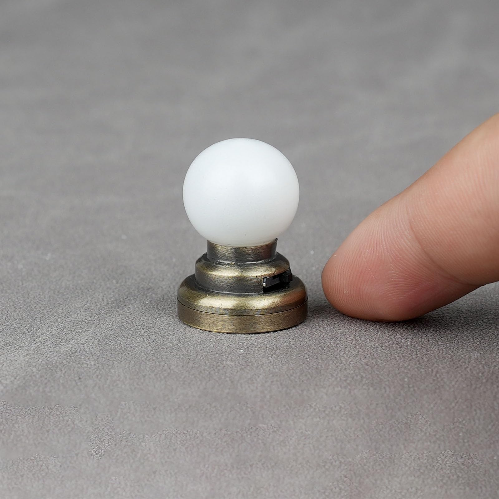 Diorama-ready brass ceiling light adds a gentle, diffused glow.