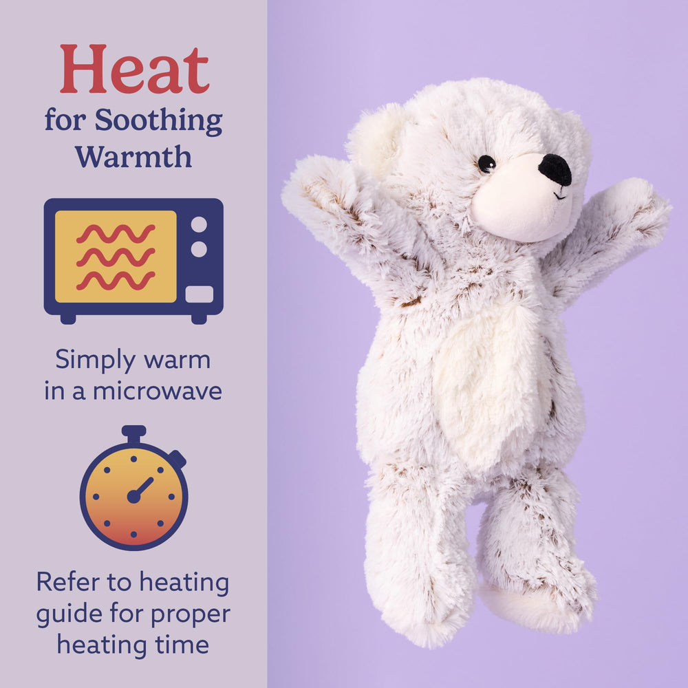 Warmies gray bear in microwave, heat-ready for soothing warmth.