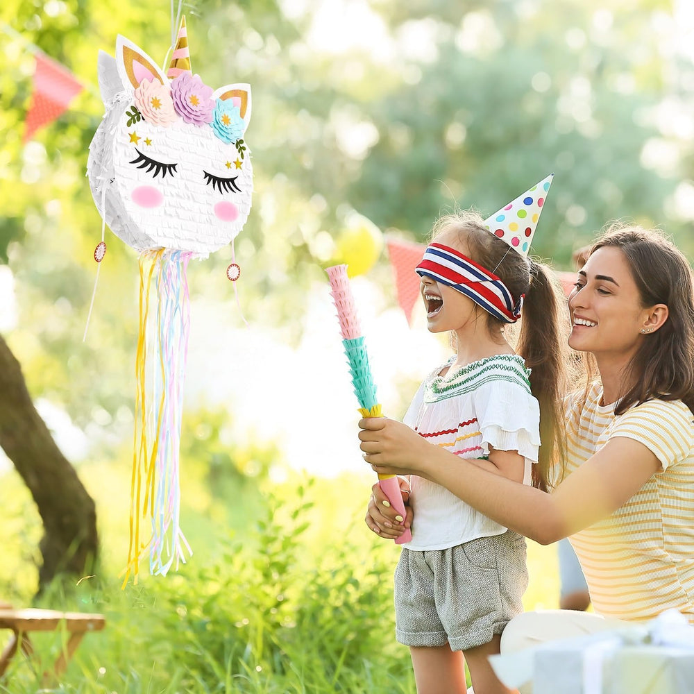 WERNNSAI unicorn pinata in use during a playful birthday game.